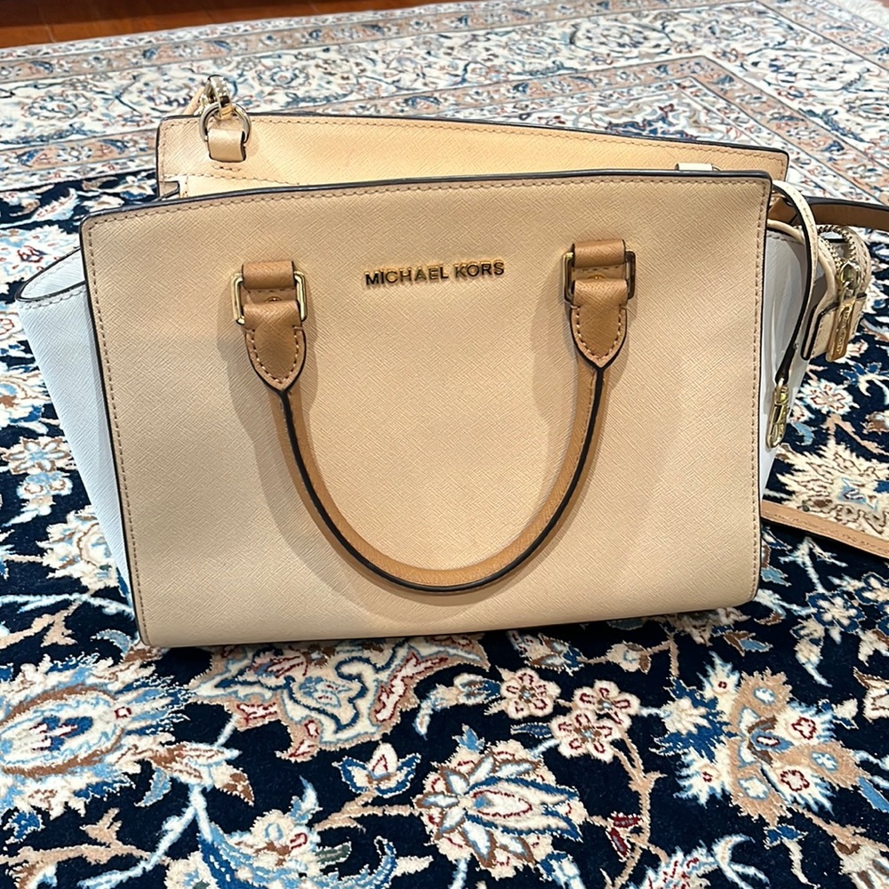 Michael kors  purse front is clean. Back has a few pen marks